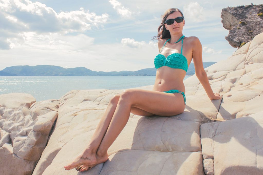 Woman in a bikini by the water